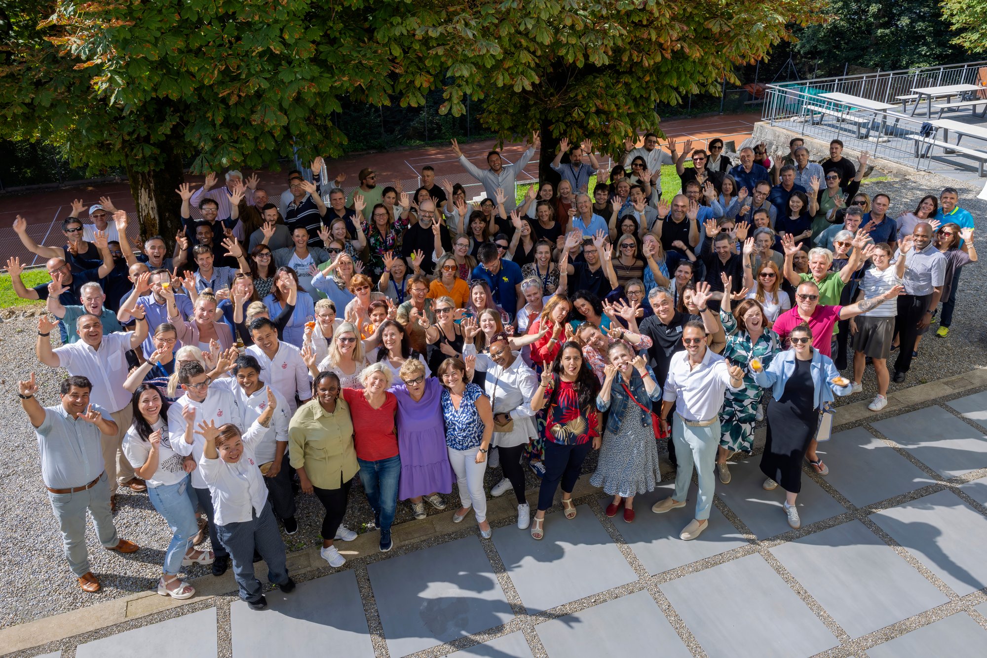 A group of people pose on a terrace. 